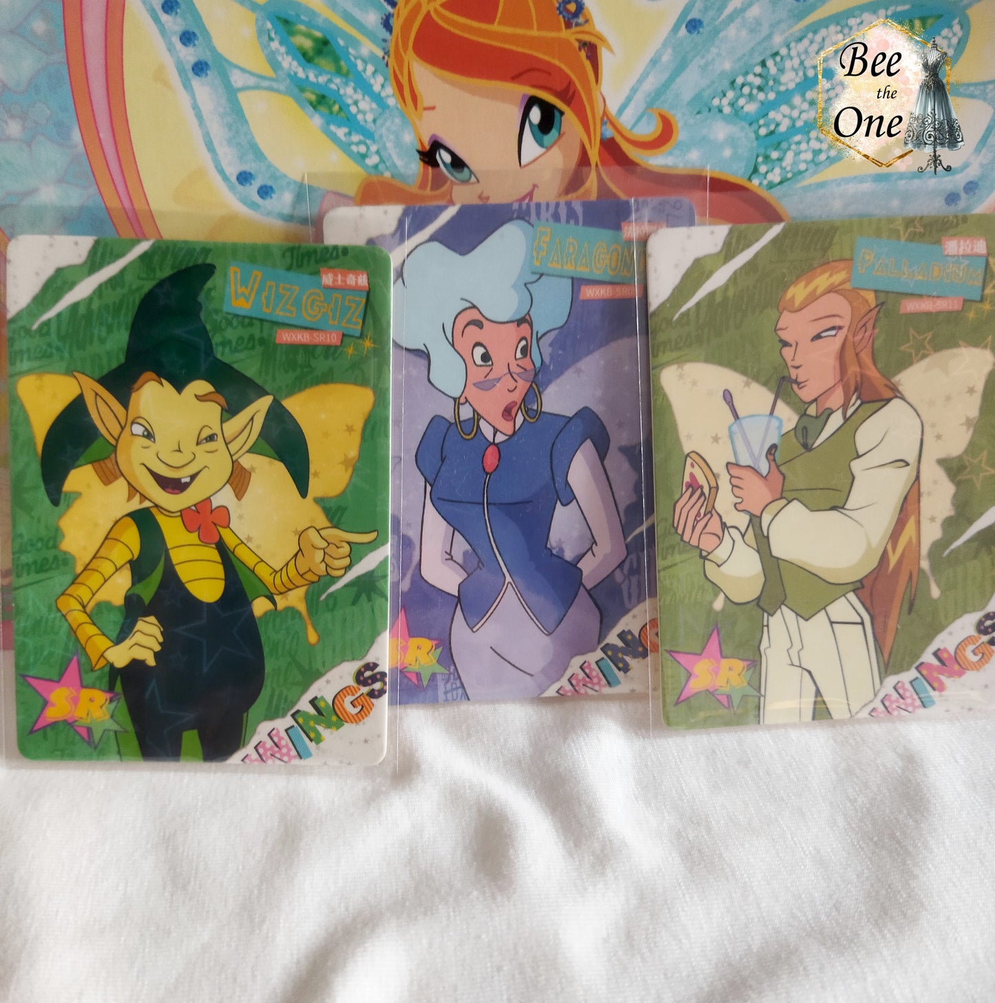 Carte à collectionner représentant un personnage de dessin animé dans un univers magique. Carte brillante